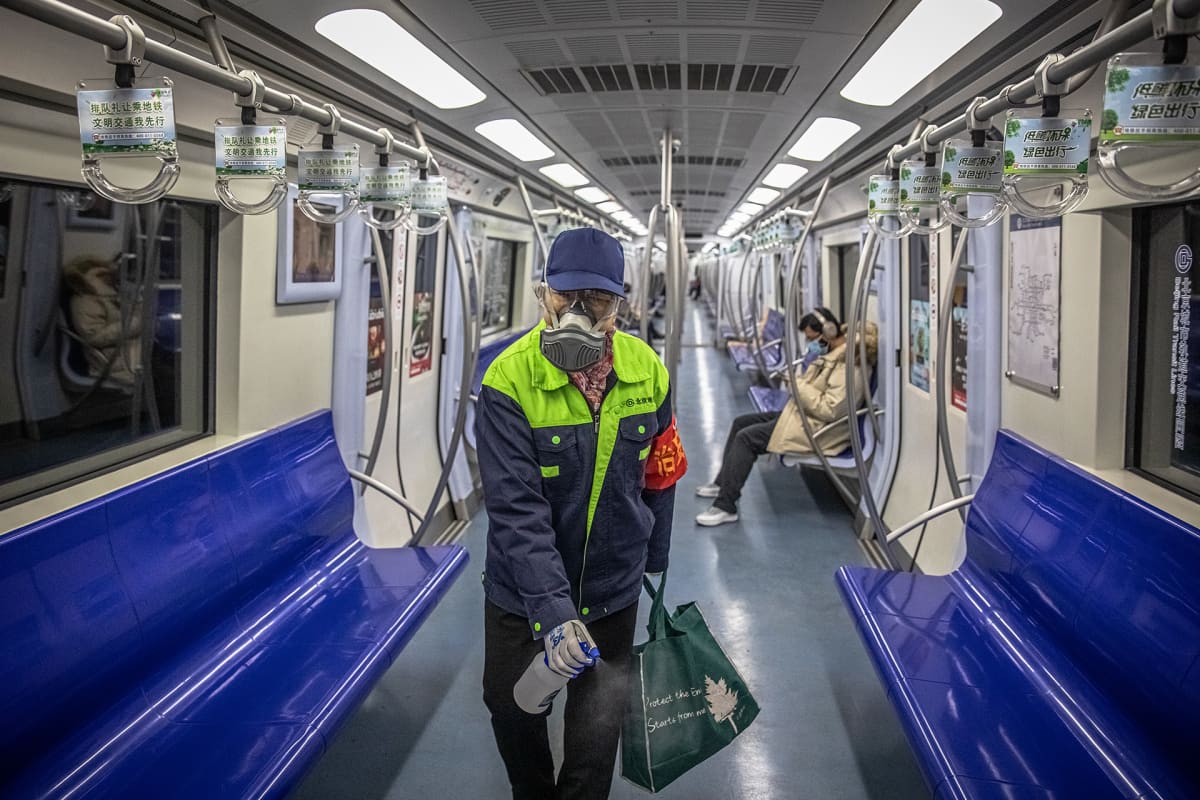 A subway worker wearing a protective face mask and eyewear disinfects a subway carriage in Beijing, China, 10 February 2020. Major China's cities began going back to work after the Lunar New Year holiday, which was extended in an attempt to contain the spread of the deadly coronavirus across the country.