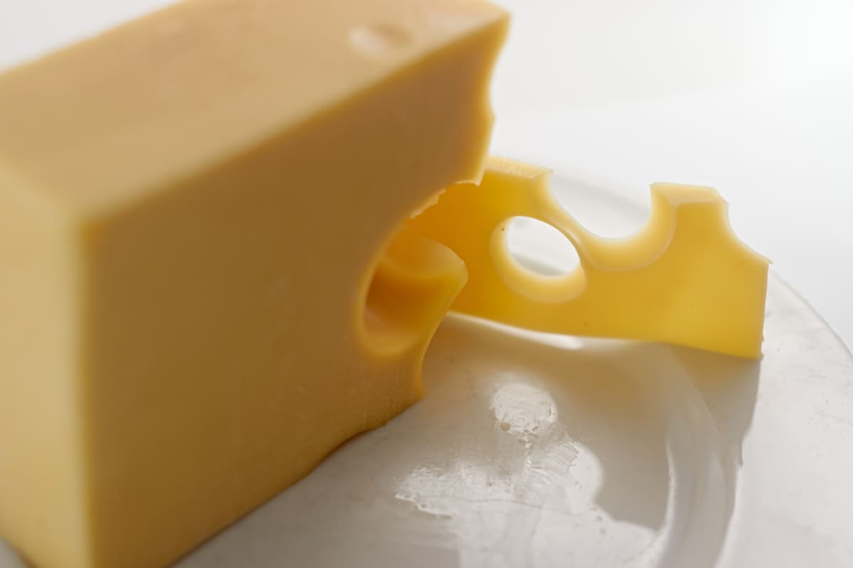 A block and slice of cheese.
