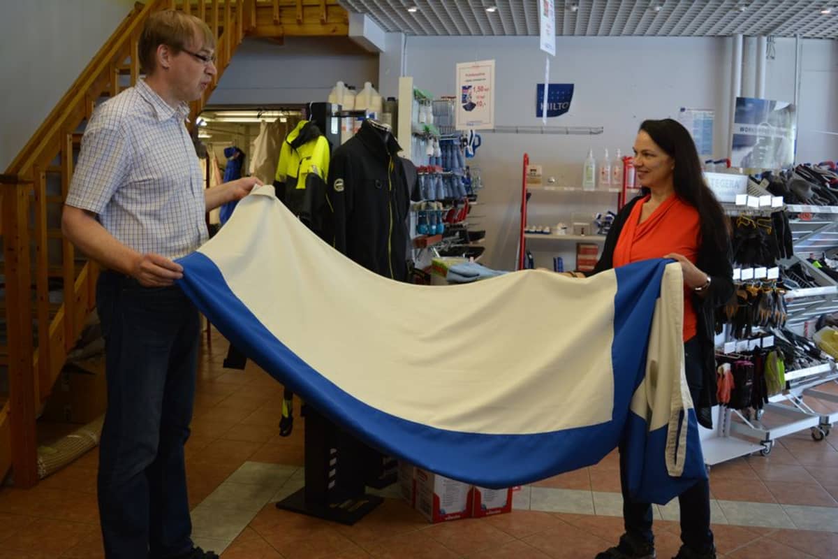 Pesulassa tutkitaan siniristilipun kuntoa.