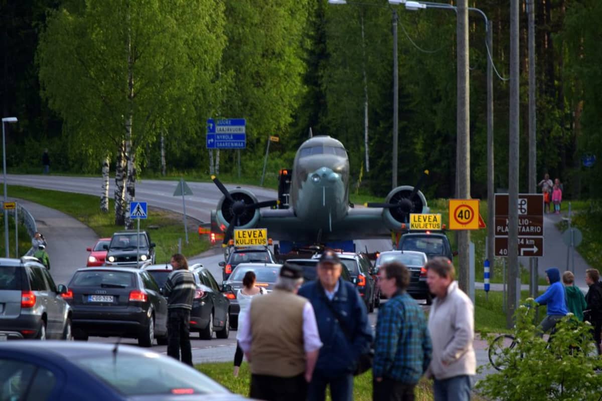 Ihmisiä seuraamassa lentokoneen erikoiskuljetusta