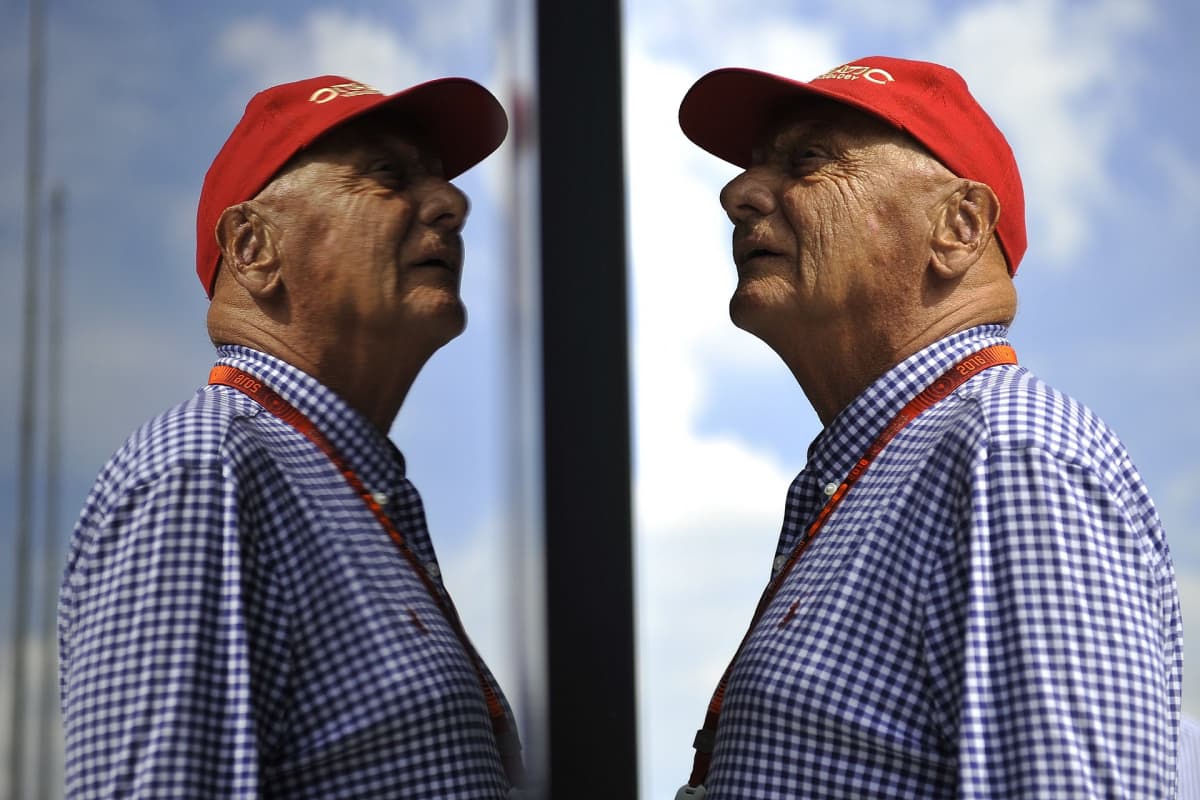 Niki Lauda katselee yläviistoon, peilikuva hänestä heijastuu kuvassa vasemmalla.
