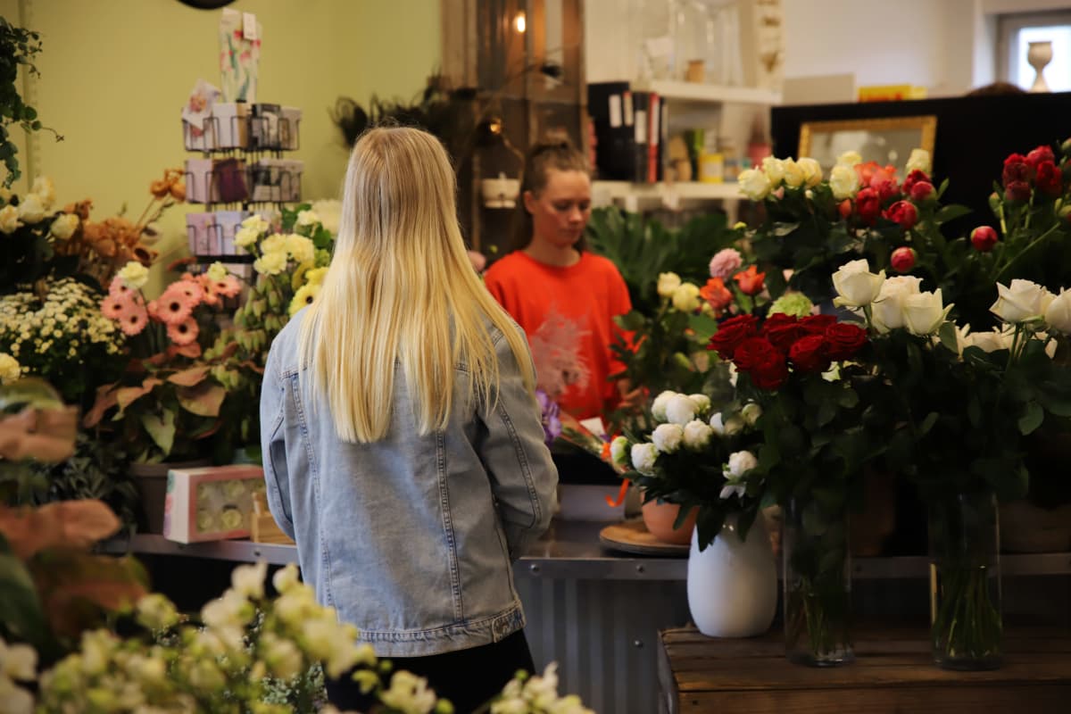 Abiturientti Venla Rantala ja myyjä Sade Tepponen haminalaisessa kukkakaupassa.