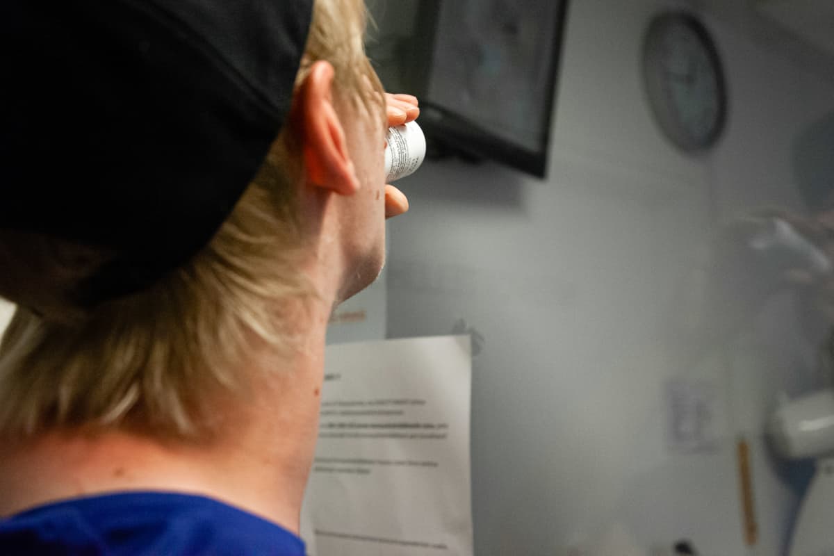 Korvaushoidon asiakas ottaa annoksen metadonia lääkkeenjaossa.