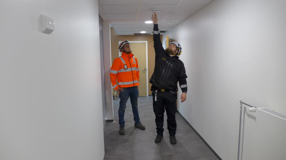 Palotarkastaja Matias Ketola ja Peabin vastaava työnjohtaja Jari Metsälä testaavat palovaroitinta.