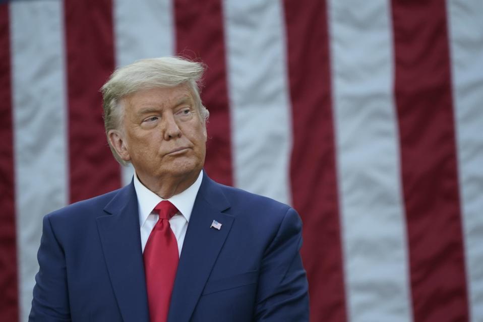 Trump taustallaan USA:n lippu.