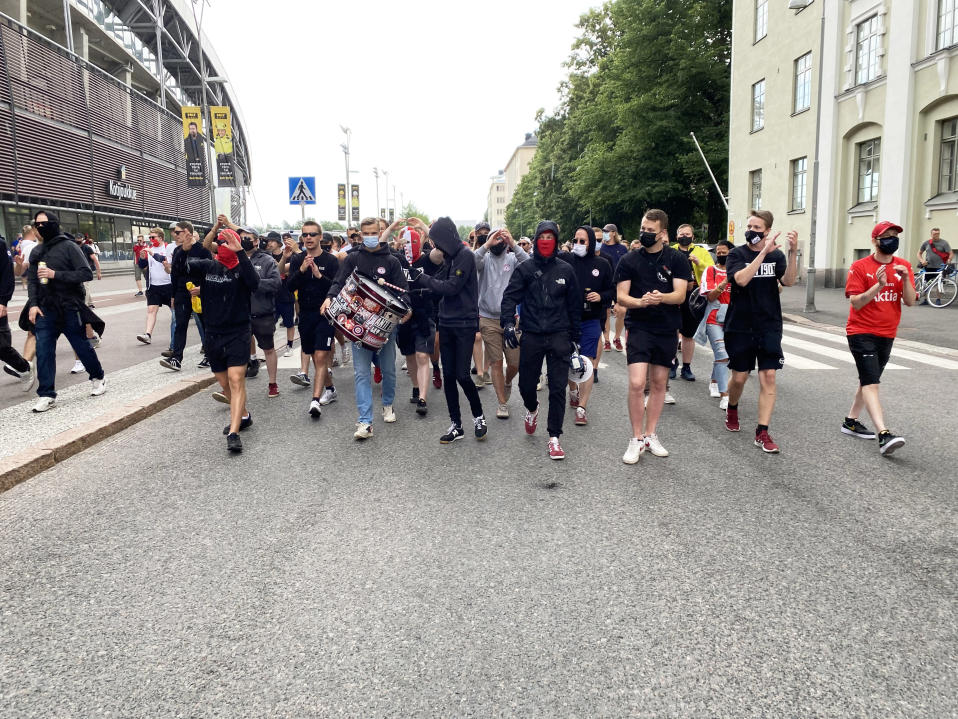 Jalkapallofanit marssivat kadulla.