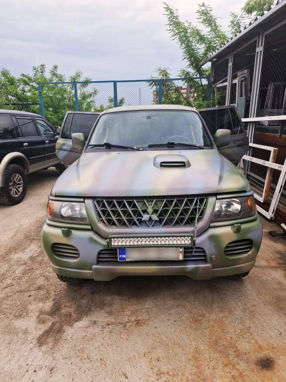 Suomesta Ukrainaan lahjoitettu maastoauto Kiovan varikolla maalattuna maastoväriin.