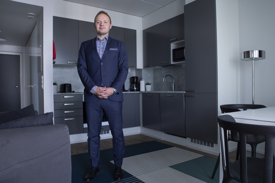 Jussi Saarinen on Forenomin operatiivinen johtaja. Taustalla näkyy kalustetun huoneiston täysin varusteltu keittiö.