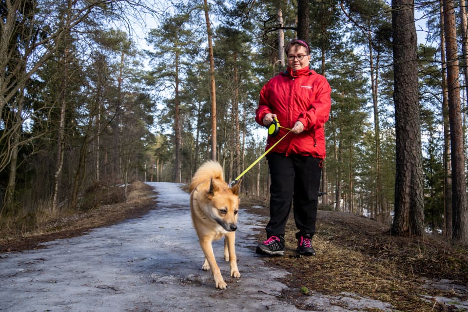 Heli Tuikka lenkillä koiransa kanssa.