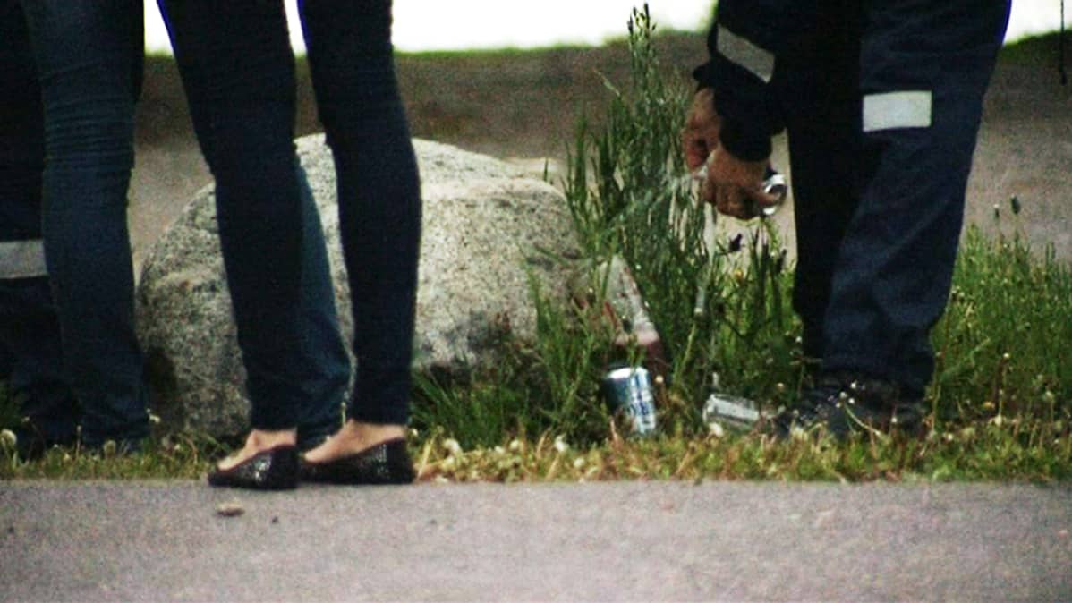 Police empty cans of underage drinkers at Hietaniemi beach. Poliisi hävitti päättäjäisviikonloppuna yli tuhat litraa vähemmän alholia kuin viime vuonna.