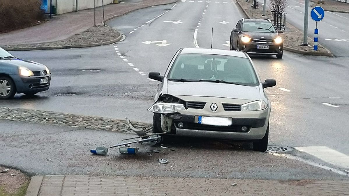 Auto kolaroinut liikennemerkin kanssa
