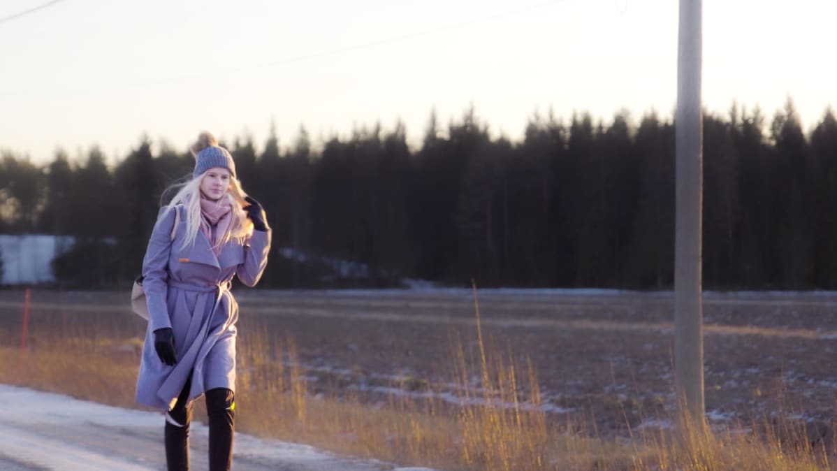 Jennifer Käld kävelee pellon laidalla.