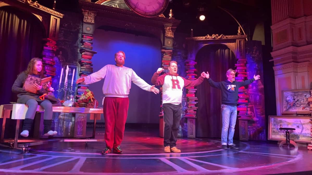 kolme miestä ja nainen teatterilavalla