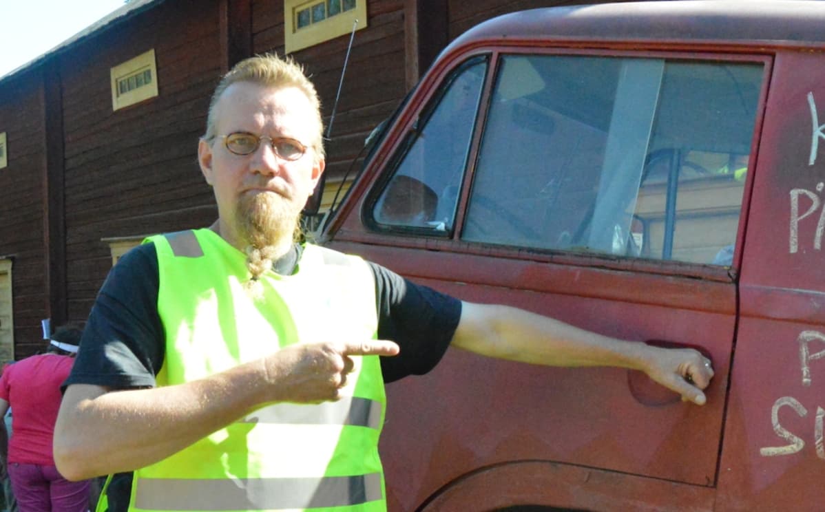 mies vanhan auton vieressä