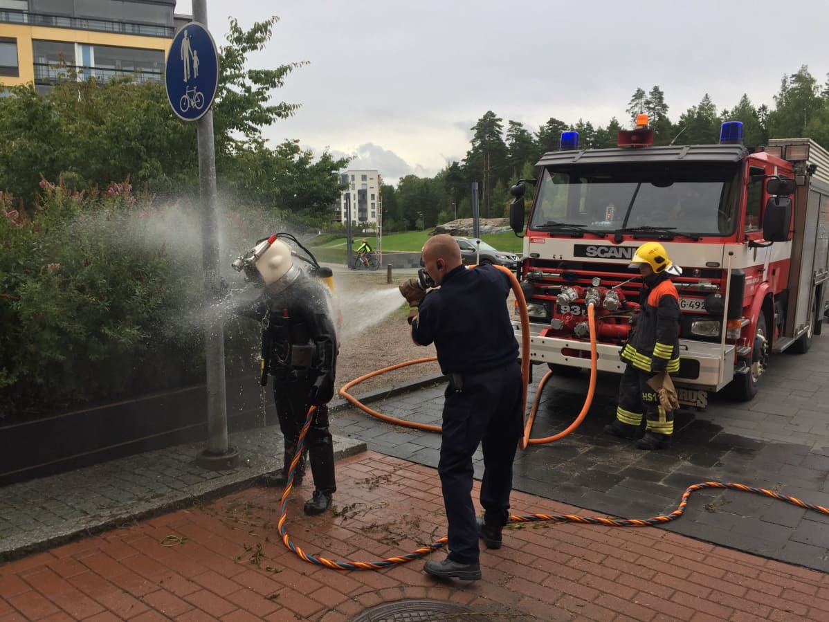 Sukeltajaa pestään suihkulla sukelluksen jälkeen.