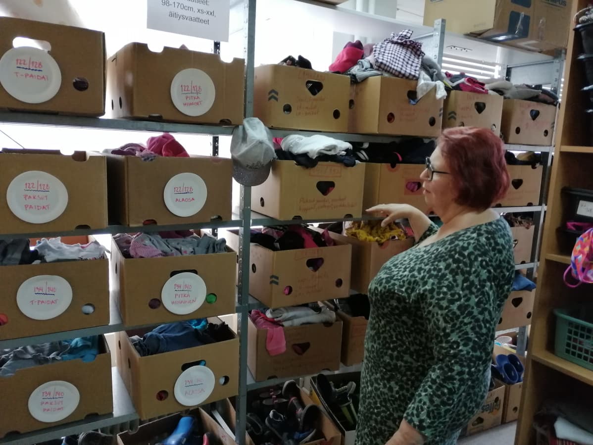 Hope ry:n vapaaehtoinen Anja Salmi esittelee lahjoituksena saatuja tavaroita.