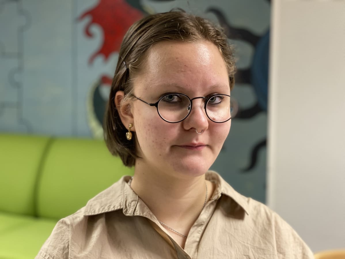 Anetta Kukkonen poseeraa kameralle lukion aulassa.