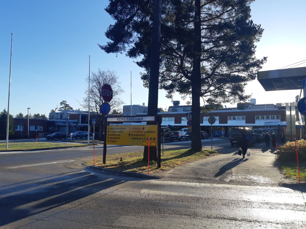 Keski-Suomen keskussairaalan päärakennus, autoja ja ihmisiä pihassa