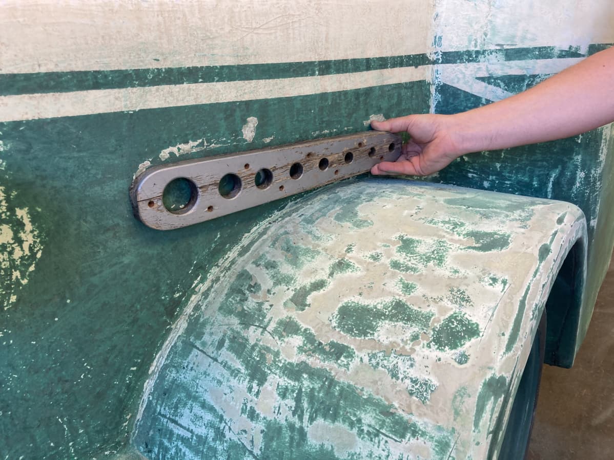 The hand holds the former bus decoration