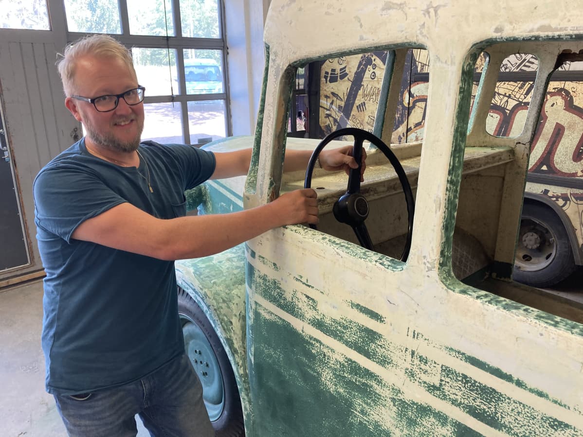 Antti Jyrkilä holds the bus wheel