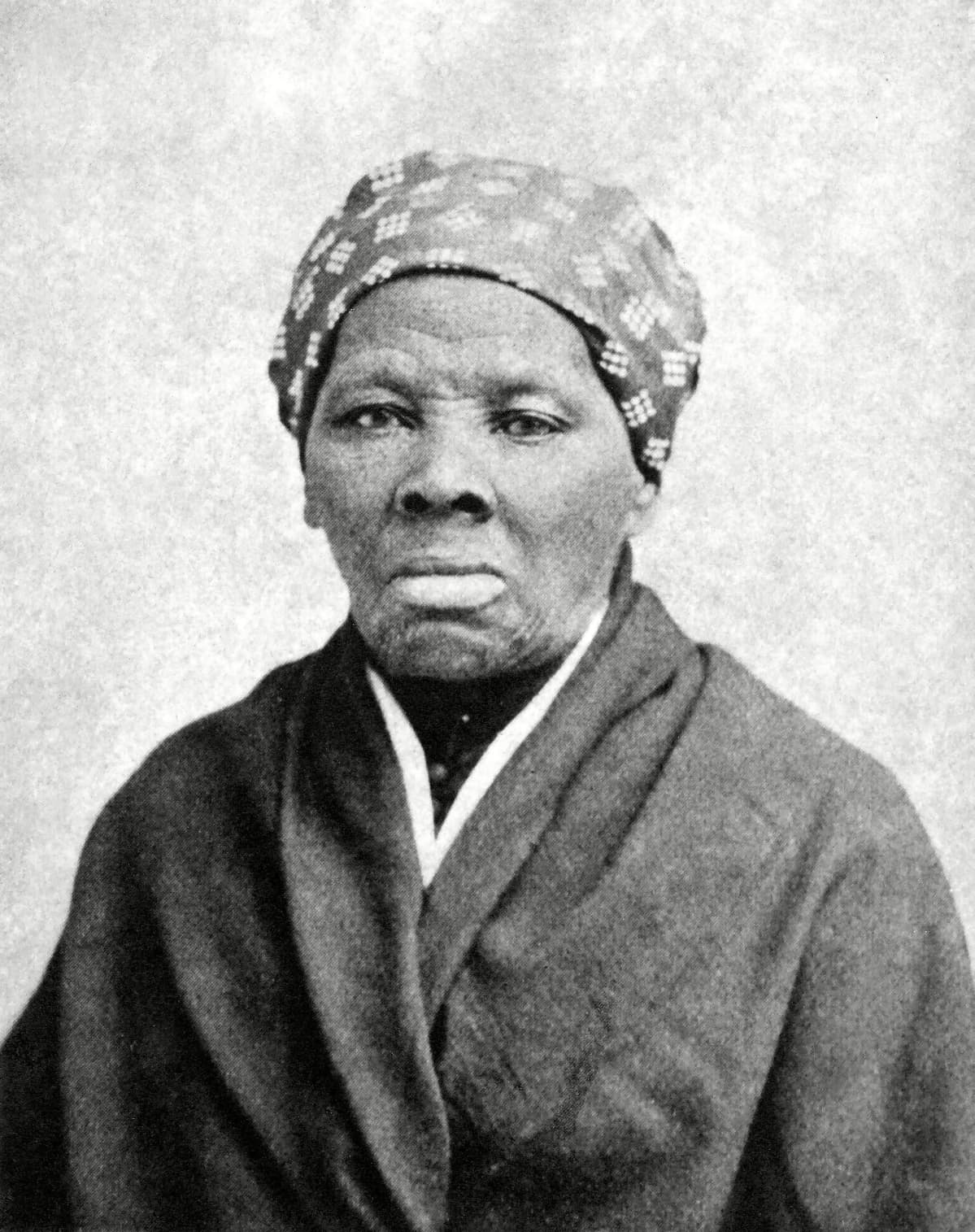 Mustavalkokuvassa on Harriet Tubman, päässään kuvioitu huivi, yllään takki.