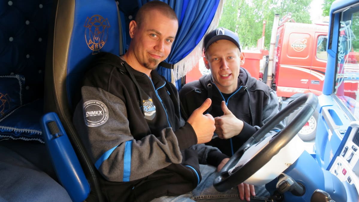 Kaksi miestä peukalot yhdessä rekan nupissa