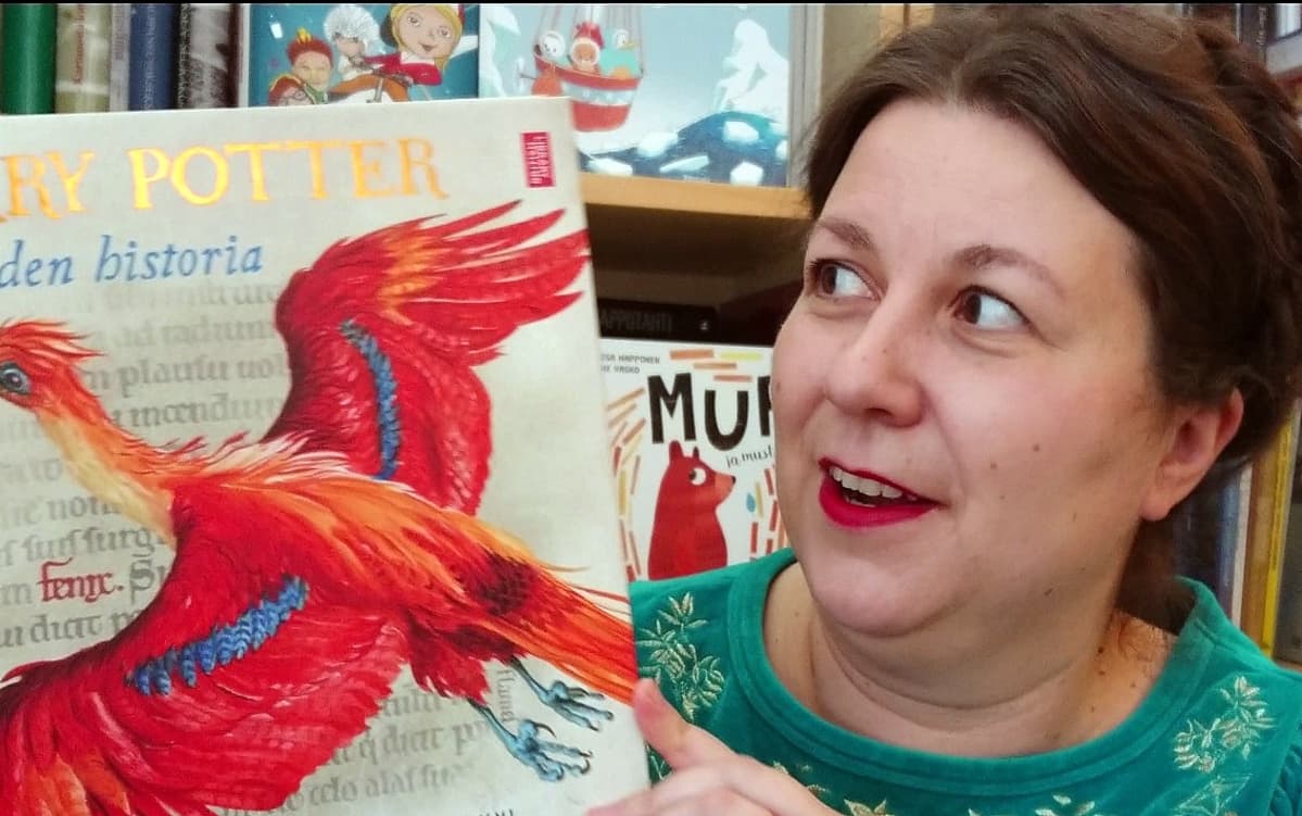 Tammen kustantaja Saara Tiuraniemi uuden Harry Potter: Taikuuden historia kirjan kanssa.