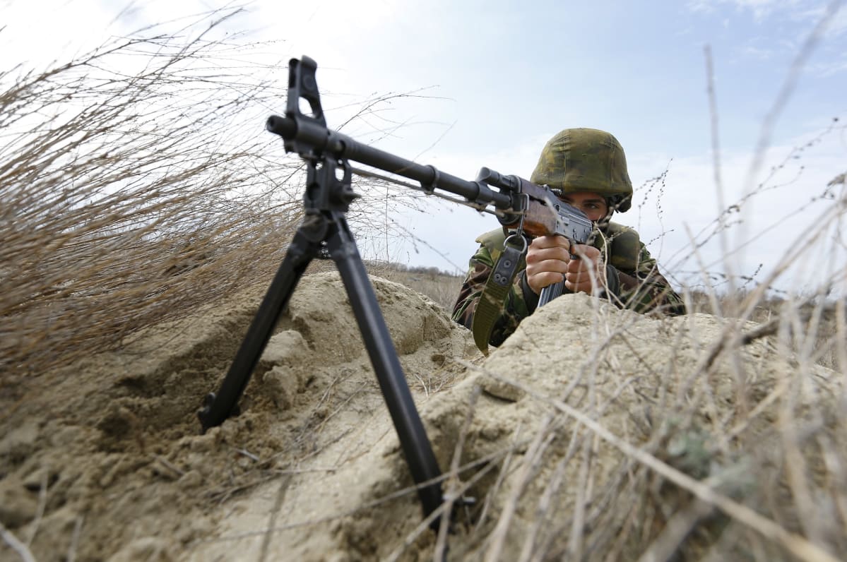 Romanialainen sotilas tähtää konekiväärillään Naton sotaharjoituksessa.