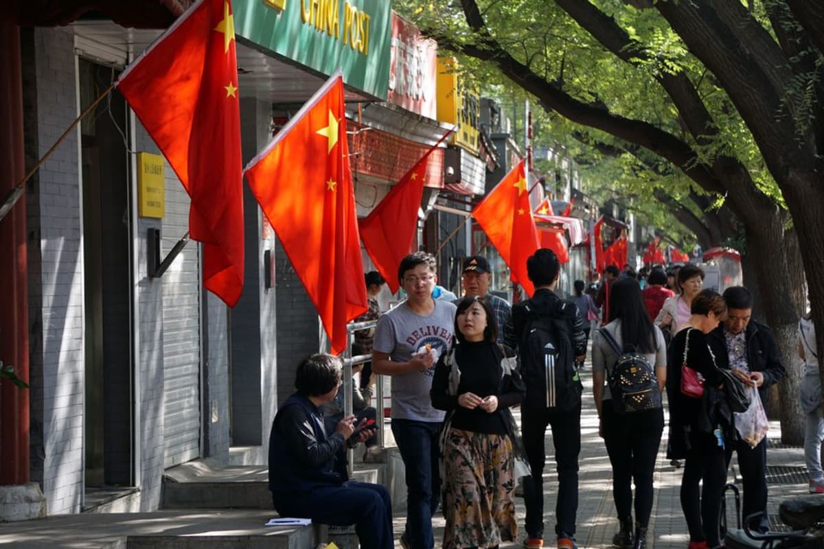 Kiinan lippuja pekingiläisten kauppojen edustalla.