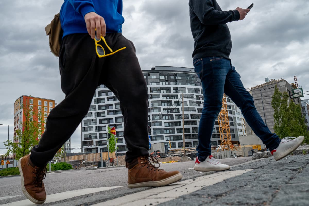 Vantaan Kivistön yleisilme on keskeneräinen. Osa rakennuksista on valmiita, osa vielä tekeillä. Kaksi nuorukaista ylitää suojatietä.