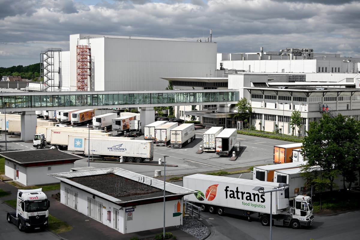 Lihantuotantolaitoksen rakennuksia, etualalla kuorma-autoja