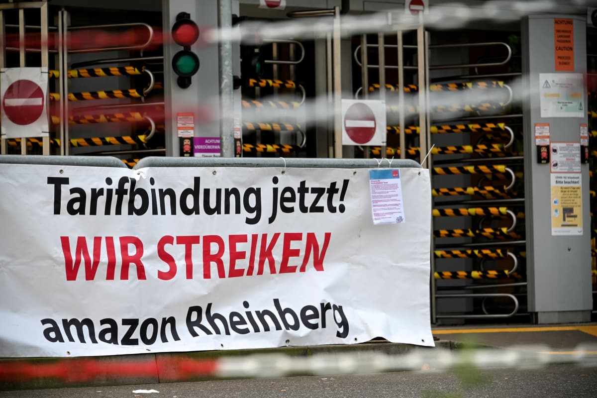Verdi-ammattiliiton esille panema mielenosoitusjuliste Amazonin jakelukeskuksessa Rheinbergissä, Saksassa. Julisteessa vaaditaan kollektiivista neuvotteluoikeutta.
