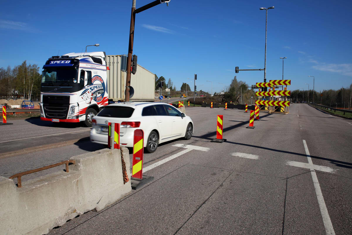 Henkilöauto kääntyy kiertoreitille Hyväntuulentieltä Kotkassa. Toisella kaistalla rekka poistuu kiertoreitiltä.