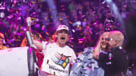 Windows95man, Teemu Keisteri, and his guest vocalist Henri Piispanen being showered with colourful confetti on a stage.