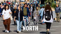 Photo shows people walking on the street in Helsinki with the All Points North logo in the centre.