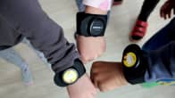 Kids wearing activity tracker wristbands.