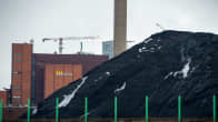 Coal pile in Suvilahti with Helsinki's Helen power plant in the background.
