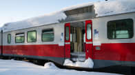 A decommissioned VR commuter train in the snow, door open.