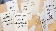 Arabian kielisiä sanakylttejä pöydällä.