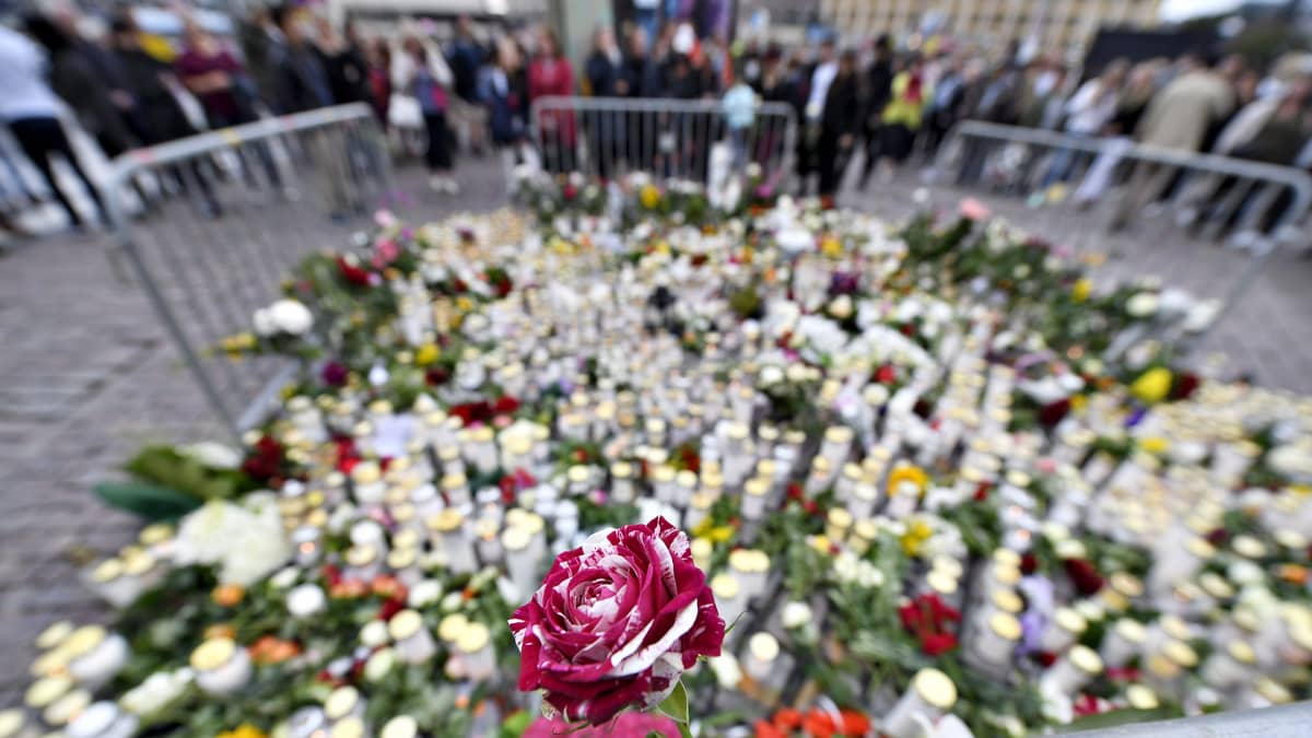 Surijat ovat tuoneet muistokynttilöitä ja kukkia Turun perjantaisen puukotusiskun uhreille Turun kauppatorille lauantaina 19. elokuuta 2017.