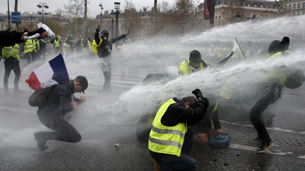 Mielenosoittajia ruiskutetaan vesitykeillä 1. joulukuuta.
