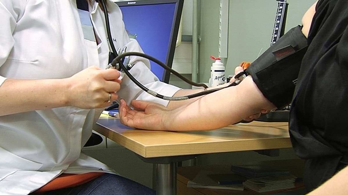 Lääkäri mittaamassa potilaan verenpainetta.
