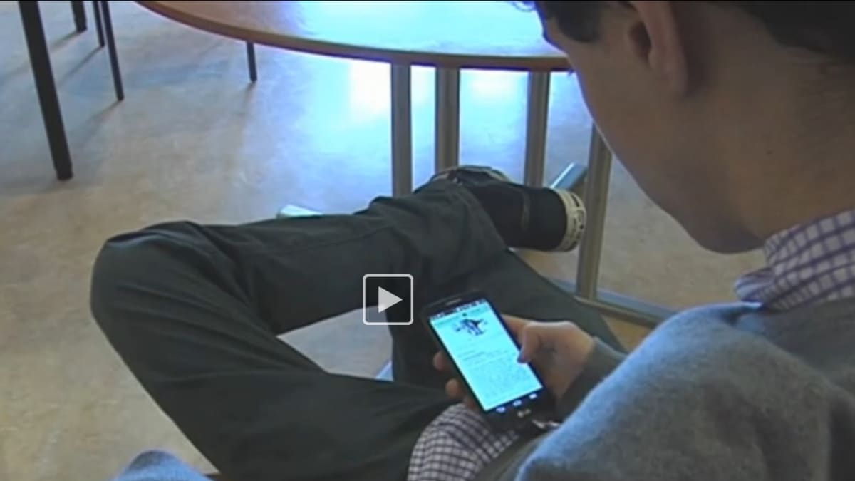 ISH student uses his smartphone in class