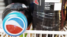 Photo shows two bottles of Pepsi on a grocery store shelf.