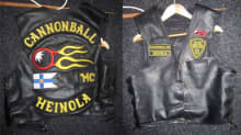 Front and back photos of a leather vest of the banned Cannonball motorcycle club..