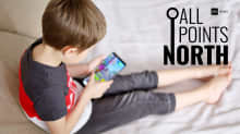 A child looking at a smartphone, next to the All Points North logo