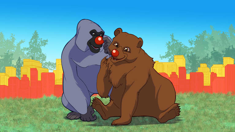 Piirretyt gorilla ja karhu hymyilevät punaiset nenät päässä nurmikolla, jonka taustalla on rakennuksia.