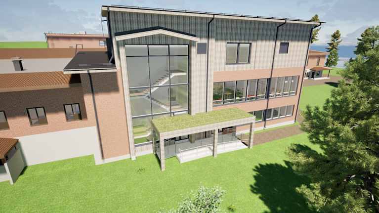 Havainnekuva, jossa on Genelecin tehtaan toimisto-osan yhteyteen tuleva kolmekerroksinen koulutus- ja elämyskeskus.