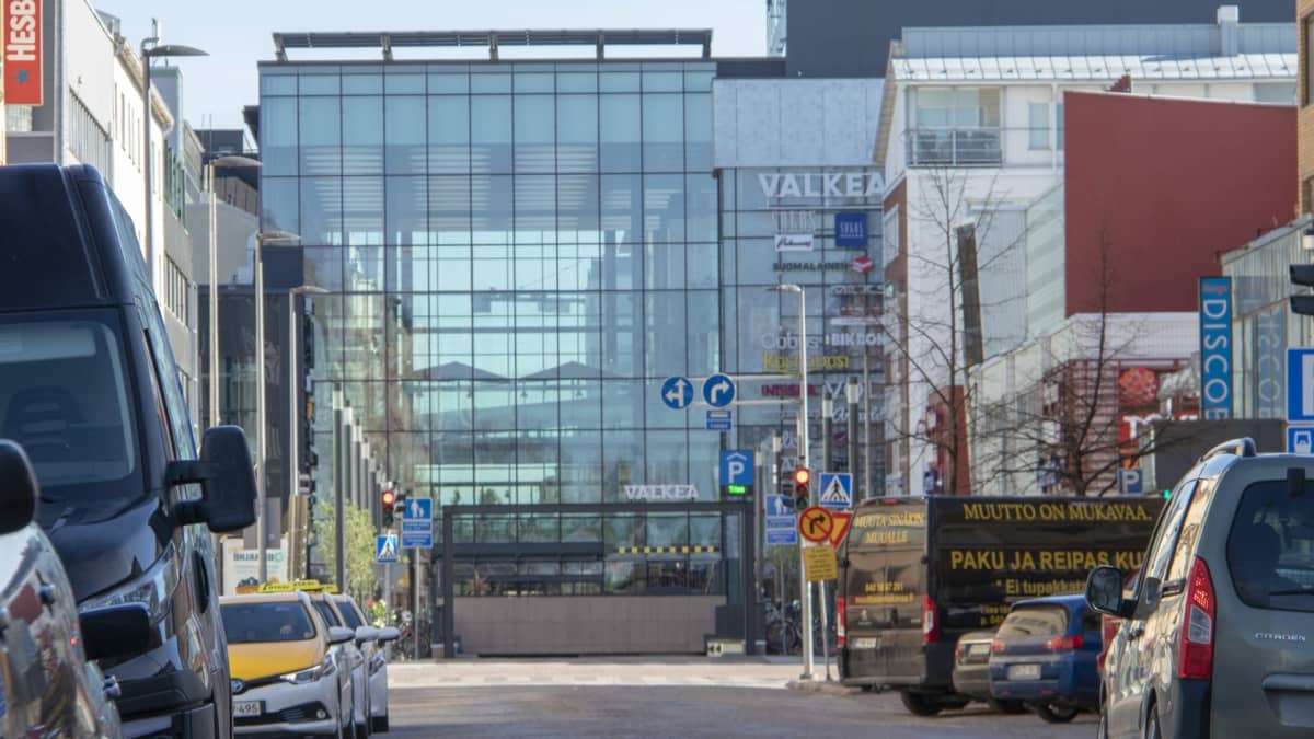 Kauppakeskus Valkea Isokadulta kuvattuna, autoja tien vieressä parkissa
