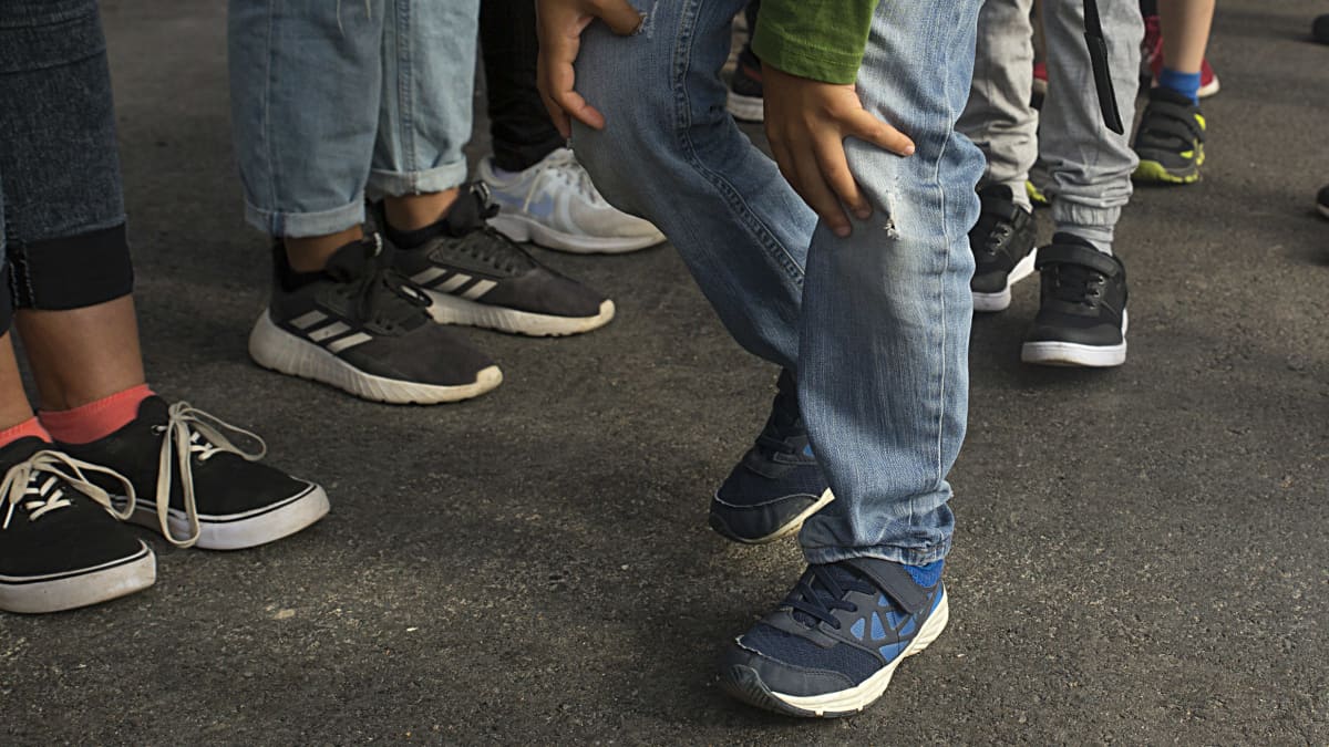 Anonymous photo featuring kids wearing sneakers and jeans.